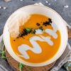Фото к позиции меню Тыквенный крем-суп с тигровыми креветками и кокосовым молоком