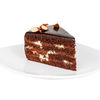 Фото к позиции меню Порция Шоколадно-орехового торта