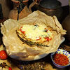 Фото к позиции меню Свинина с грибами и томатами под сыром