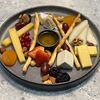 Фото к позиции меню Сырная тарелка с ягодами, орехами, медом и сухофруктами