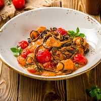 Черные спагетти с лососем в сливочно-томатном соусе
