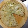 Фото к позиции меню Пирог осетинский с сыром, творогом и зелёным луком