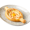 Фото к позиции меню Хачапури по-аджарски с сыром сулугуни и яйцом