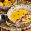 Фото к позиции меню Кукурузный крем-суп с креветкой, томатной сальсой и миксом семян