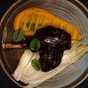 Фото к позиции меню Томлёная голень ягнёнка в терияки с пюре из батата и запечённой пекинской капустой