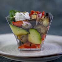 Салат с печёным баклажаном, овощами и козьим сыром