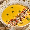 Фото к позиции меню Кукурузный крем-суп с креветкой, томатной сальсой и миксом семян