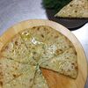 Фото к позиции меню Пирог осетинский с сыром и зеленью большой