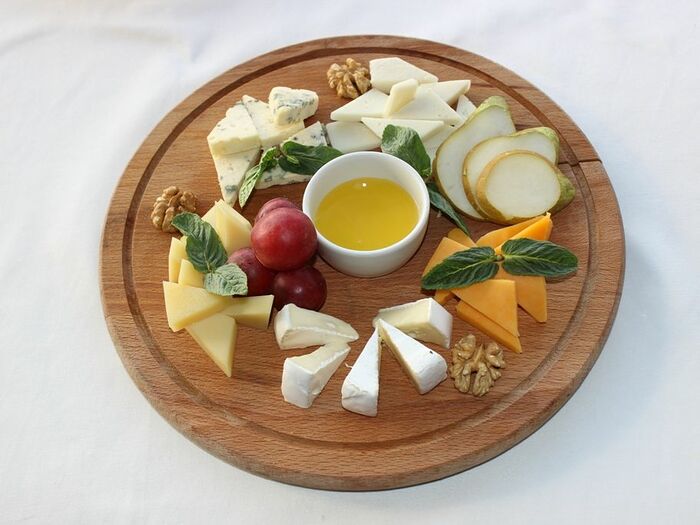 Тарелка деликатесных сыров с медом и лесными орехами