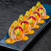 Фото к позиции меню № 41 Ролл сашими с тунцом, сибасом, лососем, креветкой, с соусом манго- маракуйя в дайконе