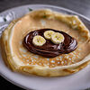 Фото к позиции меню Блин с бананом и шоколадной пастой Nutella