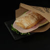Фото к позиции меню Сэндвич с ветчиной, сыром и зеленью в булочке панини