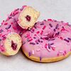 Фото к позиции меню Пончик-донатс с начинкой Лесные ягоды, розовой глазурью с розовой посыпкой